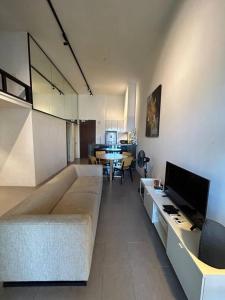 a living room with a couch and a television at KLSentral-Bangsar-MidValley-2-10pax-Netflix-Balcony-Super Fast Internet in Kuala Lumpur