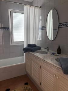 a bathroom with a sink and a mirror and a tub at HomefromHomees B&B in Sant Feliu de Guíxols