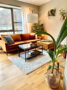 a living room with a couch and a table at Top floor apartment with mountain view, terrace 22sqm, free parking in Bergen