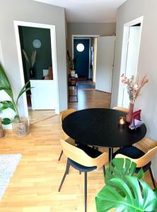 a dining room with a black table and chairs at Top floor apartment with mountain view, terrace 22sqm, free parking in Bergen