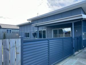 a blue house with a blue garage at Modern on McMillan in Methven
