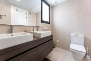 a bathroom with a sink and a toilet and a mirror at Holiday apartment Middle Views in Fuengirola +14 photos