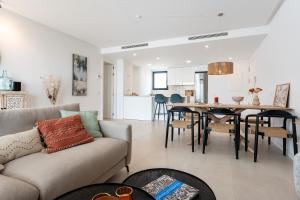 a living room with a couch and a table at Holiday apartment Middle Views in Fuengirola