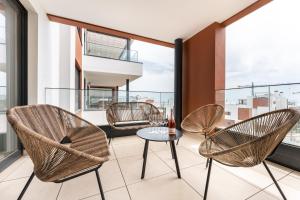 a room with chairs and a table on a balcony at Holiday apartment Middle Views in Fuengirola