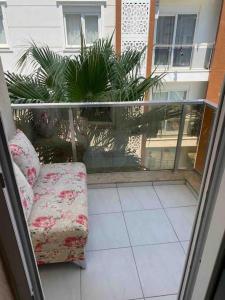 a balcony with a couch sitting on a floor at Antalya liman Apartment 1+1 in Antalya