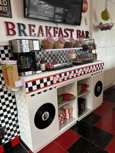 a breakfast bar in a kitchen with a checkered floor at Gleninver Guest House in Inverness