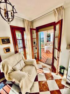 a living room with a chair and a table at Luxury Puebla Aida with Golf & Sea View in Mijas Costa