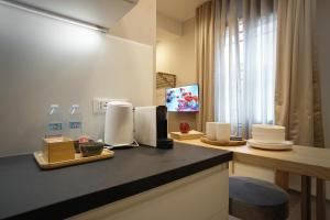 a kitchen with a counter top with towels and water bottles at 3L Luxury Rooms in La Spezia