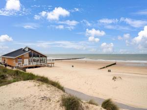 a house on the beach next to the ocean at Charming apartment in Zeeland with beautiful sea view in Cadzand-Bad