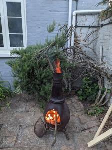 a pot with a fire in it next to a house at Cliffside in Cowes