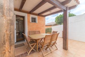 a wooden table and chairs on a patio at Villa Bella in Conca Verde