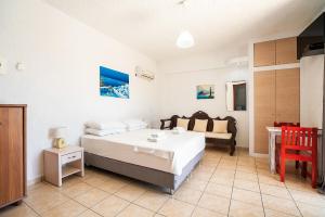 A bed or beds in a room at Kiotari beach garden view-sea view