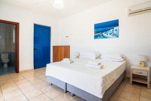 A bed or beds in a room at Kiotari beach garden view-sea view