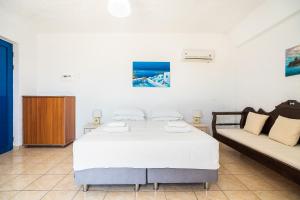 A bed or beds in a room at Kiotari beach garden view-sea view