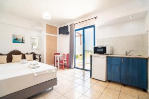 A bed or beds in a room at Kiotari beach garden view-sea view