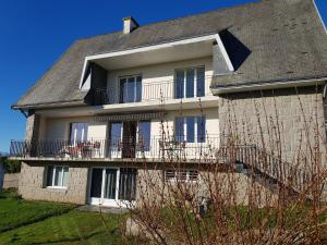 a large house with a balcony on top of it at Les Balcons du Trégor in Lannion