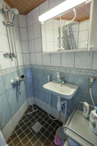 a small bathroom with a sink and a mirror at Kodikas Studio in Tampere