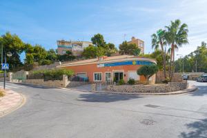 an orange building on the side of a street at Apartment Sandra by the sea in El Campello
