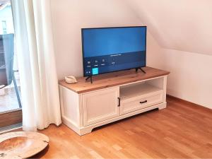 a flat screen tv sitting on top of a cabinet at Ferienhaus Lucia in Hilzingen