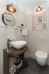 a bathroom with a sink and a toilet at Amaizing apartment near Airport in Kastel Stafilic