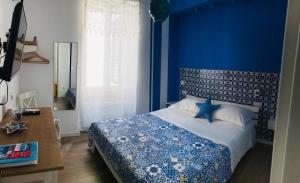 Postel nebo postele na pokoji v ubytování B&B Via dell'Azzurra