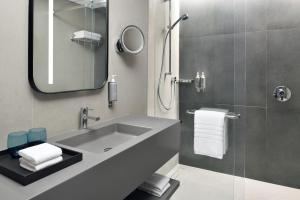 a bathroom with a sink and a mirror at Courtyard by Marriott World Trade Centre, Dubai in Dubai