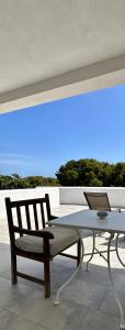 a chair and a table with a laptop on a balcony at Dimora delle Tonnare in Favignana