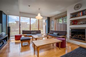 a living room filled with furniture and a fireplace at Asobidokoro in Kutchan