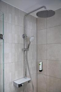 a shower with a shower head in a bathroom at Hotel Imhof in Gemünden
