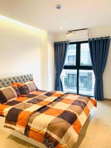 a bedroom with a bed and a large window at Urban Village Night Stay in Phnom Penh