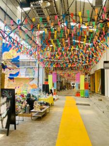 a large room with colorful kites hanging from the ceiling at Urban Village Night Stay in Phnom Penh