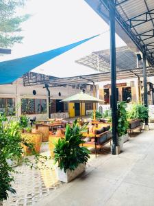 a restaurant with tables and chairs and an umbrella at Urban Village Night Stay in Phnom Penh
