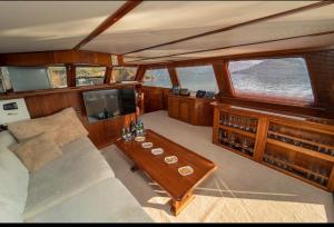 a living room with a couch and a table in a boat at Aden yachting in Göcek