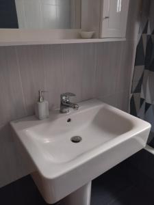 a white sink in a bathroom with a mirror at B&B one in Vonitsa