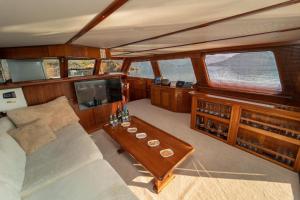 a living room of a boat with a couch and a table at Aden yachting in Göcek