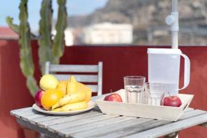 a wooden table with a plate of fruit on it at El Altillo House in Moya