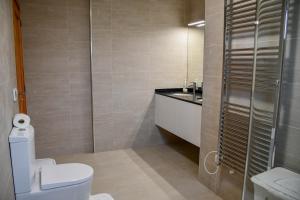 a bathroom with a toilet and a sink at Casa do Cantinho do Muro in São Vicente