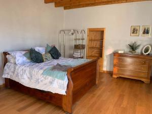 a bedroom with a bed and a dresser at Lovely House in Quiet Hamlet on banks of the Lot in Saint-Martin-Labouval
