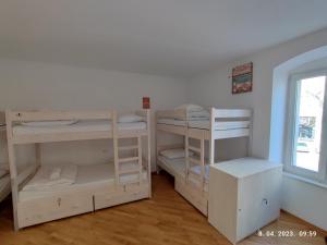 a room with three bunk beds and a window at Impact House Split in Split
