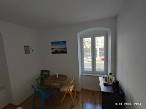 a living room with a table and a window at Impact House Split in Split