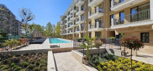 an apartment building with a swimming pool in a courtyard at Emilia Romana Park in Sunny Beach