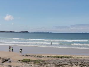 a group of people walking on the beach at PENICHE - Guest House Casa das Estelas in Peniche