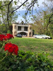 una casa con flores rojas delante de ella en B&B Villa Torri Petrose en Pontelatone