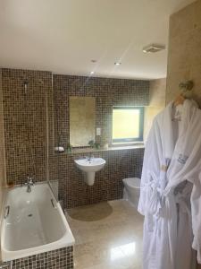 a bathroom with a bath tub and a sink at Sea Vista Boutique Accommodation in Fahan +53 photos
