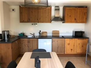 a kitchen with wooden cabinets and a wooden table at Chalet Cosy in Saint-Gervais-les-Bains