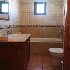 ein Badezimmer mit einem Waschbecken, einem WC und einer Badewanne in der Unterkunft La Barrica in Soo