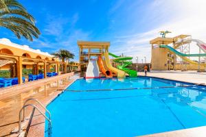 a swimming pool with a water slide at a resort at Golden Beach Resort in Hurghada