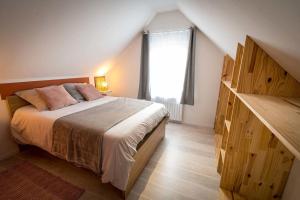 a bedroom with a large bed and a window at La Longère Gasiaquoise in Gauchy