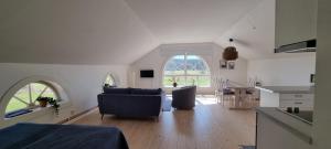 a kitchen and living room with a table and chairs at Kiladalens Golf & Lodge in Nyköping