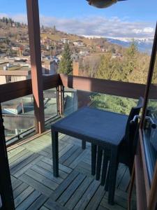a blue table on a balcony with a view at Duplex St Gervais rooftop - 500m des télécabines in Saint-Gervais-les-Bains